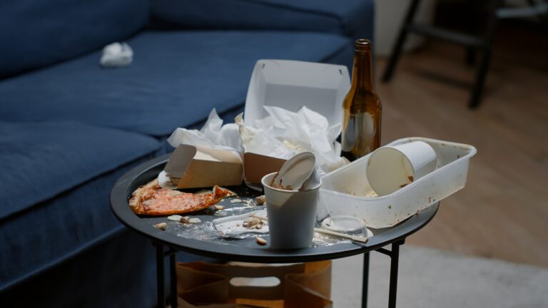 Close up of leftover food on table in empty messy living room