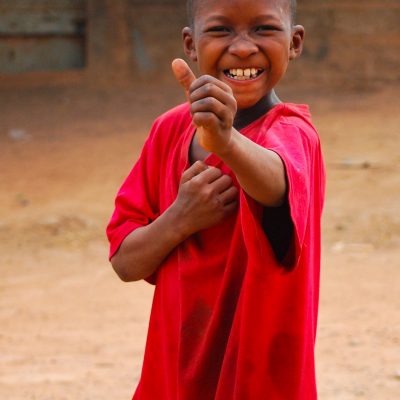 african-black-boy-smiling-in-the-camera-making-a-pose-travel-africa-volunteer.jpg