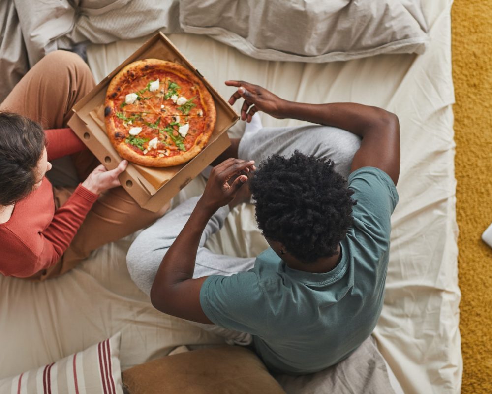 Couple eating in bed