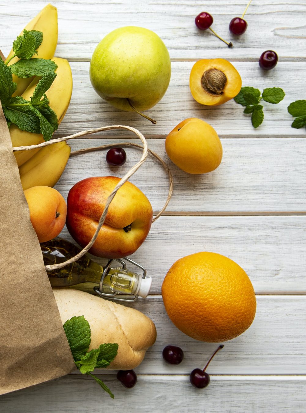 Healthy food background. Healthy food in paper bag, fruits and berries
