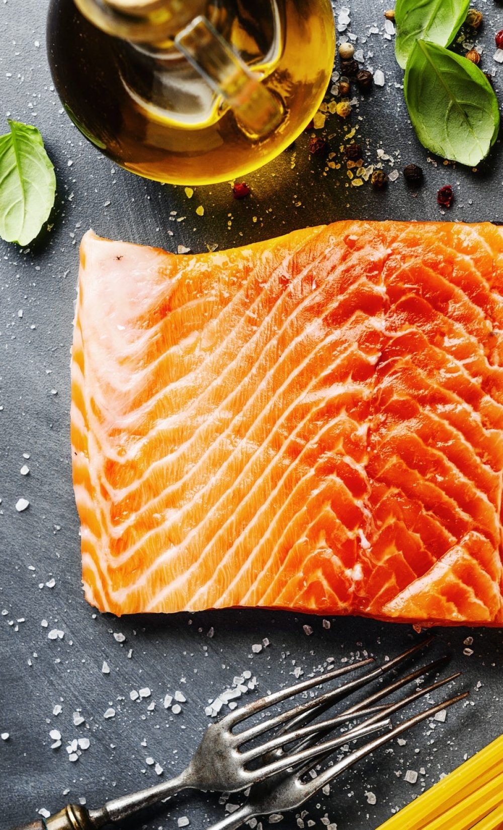 Salmon with ingredients on table