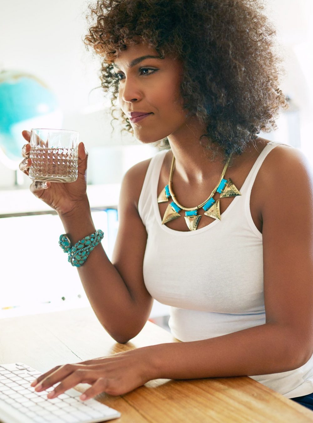 Young businesswoman drinking water